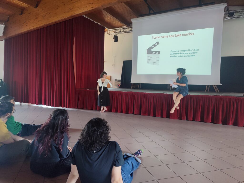 Young people attending a workshop on video editing, with a facilitator presenting a video editing tool on a projector screen.